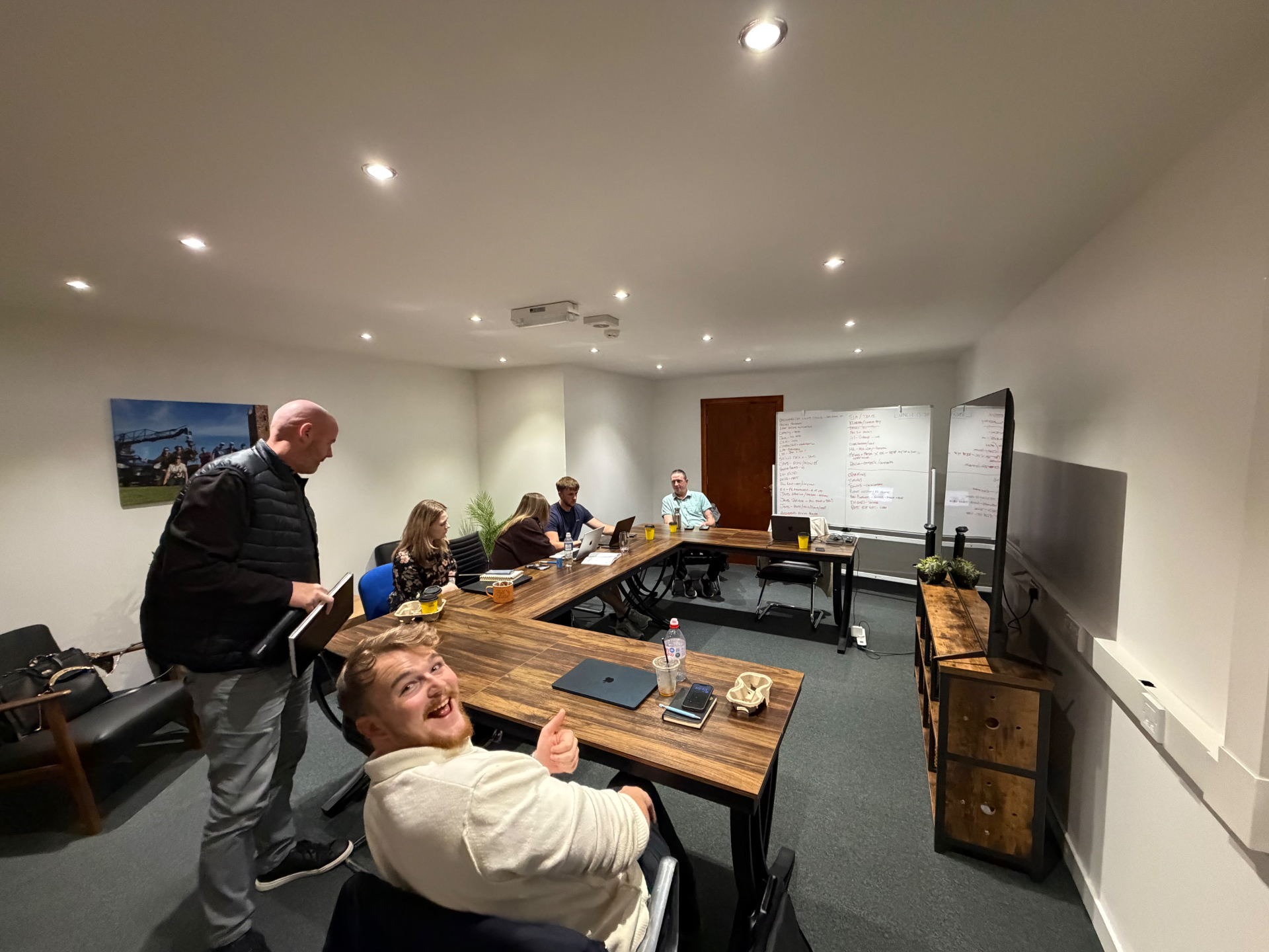 River House boardroom set out for a workshop, with whiteboards and a large screen